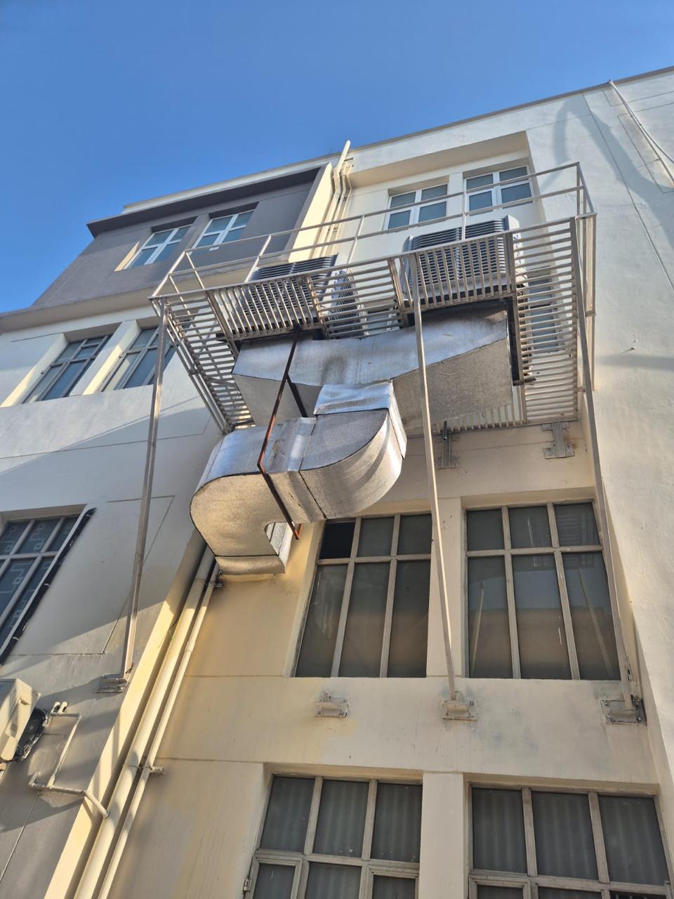 GI ducting installed along a building facade for ducted air cooling.